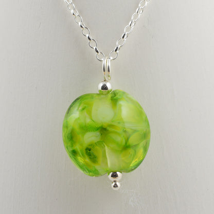 Shades of green lentil shaped glass bead pendant on silver chain