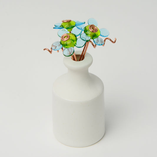 'Cool Skies' bouquet of three turquoise glass daisy flowers in a miniature bottle vase