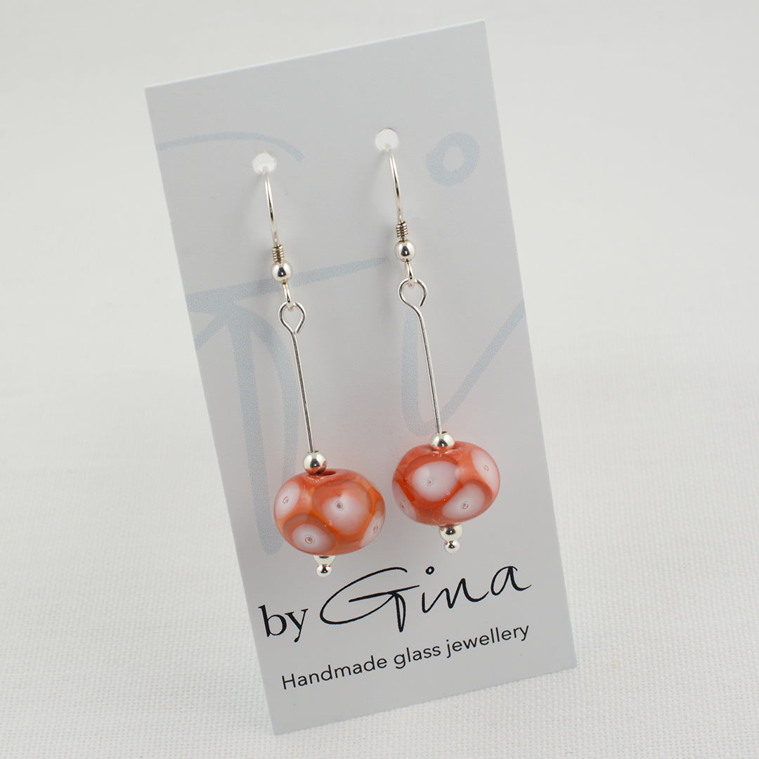 Coral glass beads with white glass details and trapped air bubbles on silver drop earrings