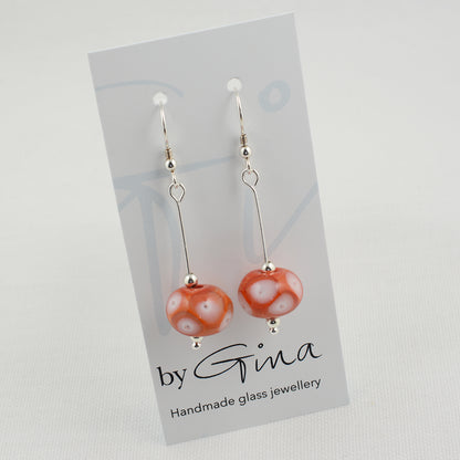 Coral glass beads with white glass details and trapped air bubbles on silver drop earrings